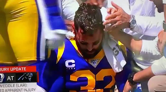 eric-weddle-christian-mccaffrey-knee-bleeding.jpg